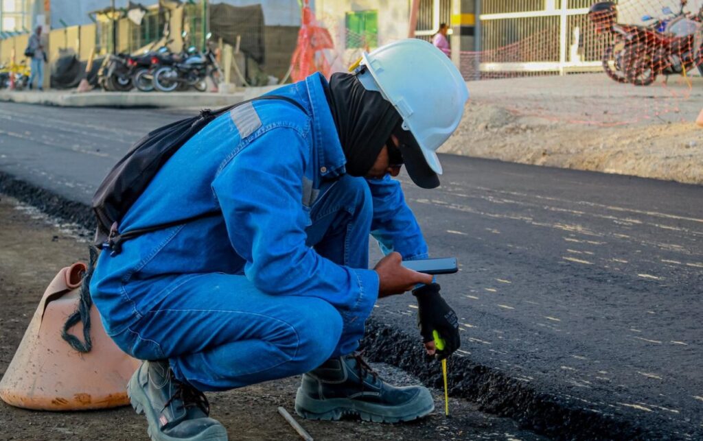 Operario realiza control técnico del espesor en la carpeta asfáltica de los 690 metros intervenidos en la nueva conexión vial del intercambiador de La Carolina.